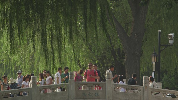 Director Jim Fields from Studio Output attempting to clear people long enough for a three shot sequence on a busy bridge in beijing.