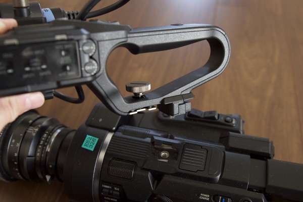 The camera features a removable top handle with XLR inputs and full audio controls