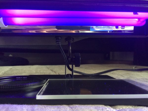 Charging the filters under a UV lamp
