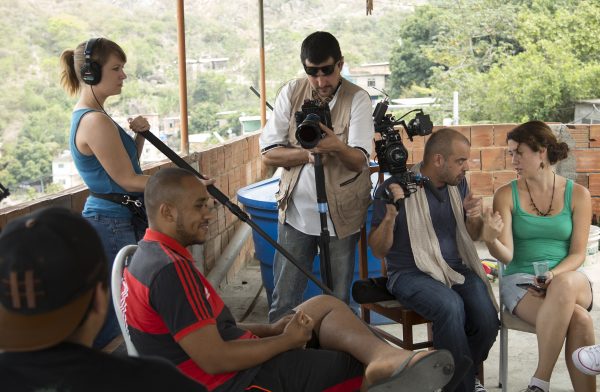 Director Orlando de Guzman (seated) and Producer Lorien Olive (holding boom) in Complexo do Alemao, Rio de Janeiro.